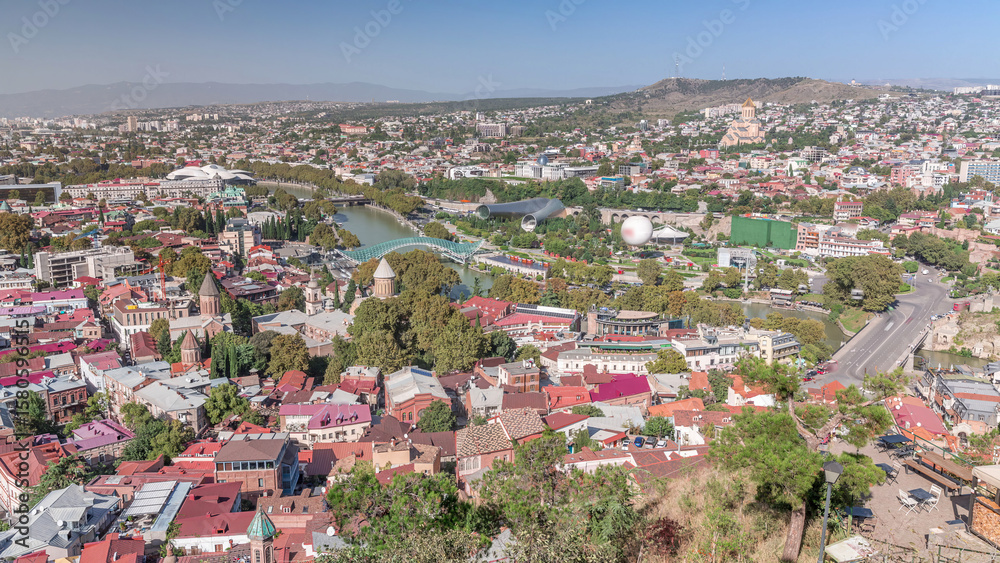Fototapeta premium Colorful traditional houses with wooden balconies and red roofs in the Old Town of Tbilisi aerial timelapse, Georgia.