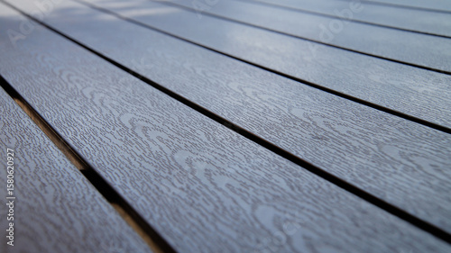Close-up of modern composite outdoor table with a subtle wood grain texture, perfect for outdoor living, patios, and sustainable construction concepts.