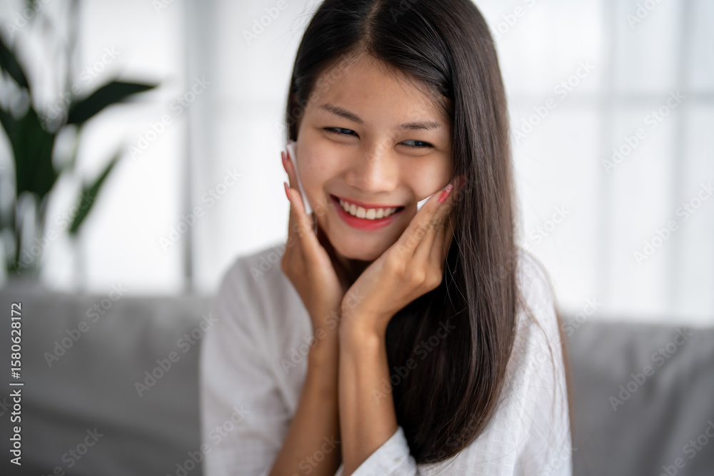 Daily beauty routine Asian woman
with clean skin uses micellar water to remove makeup Daily beauty routine Asian woman
with clean skin uses micellar water to remove makeup