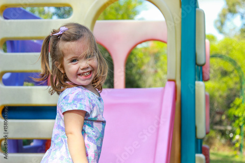 Little girl looking over her shoulder and grinning