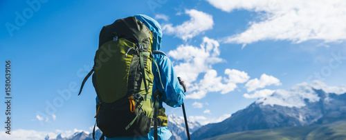 Foto Backpacking woman hiking on flowering grassland mountain top