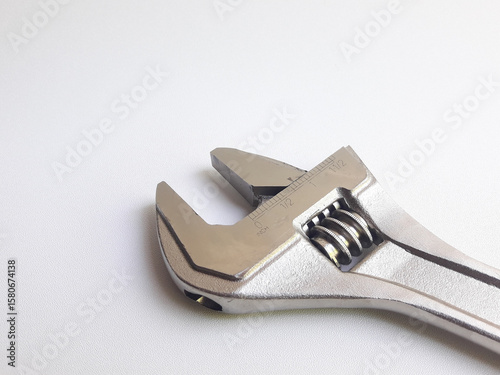Fotografi A wrench, also known as an adjustable wrench, is shown on a white background