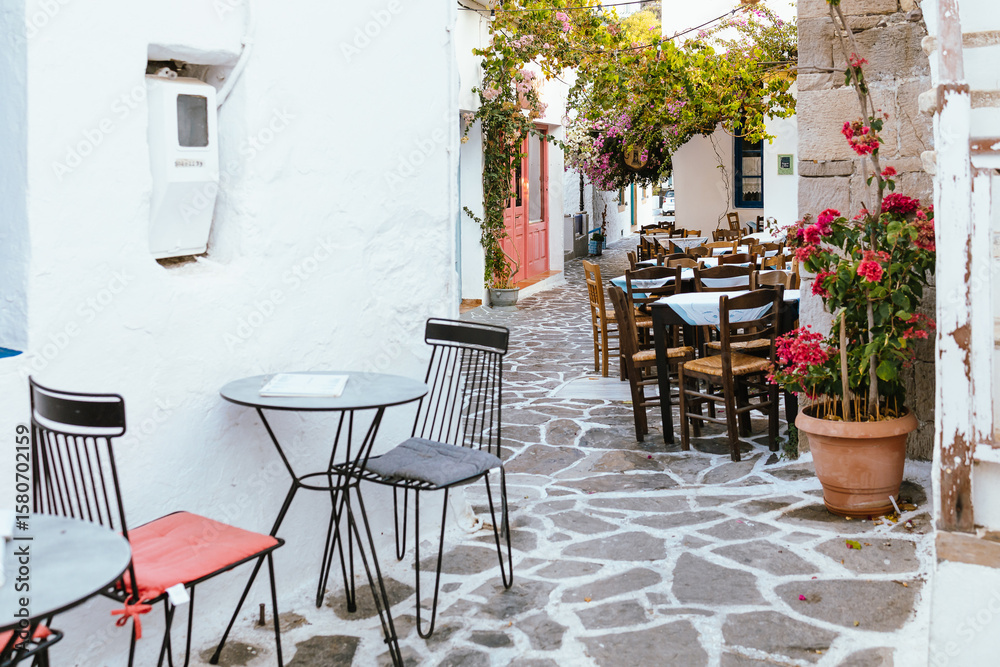 Fototapeta premium Cozy cafe terrace in Plaka village, Milos island, Greece