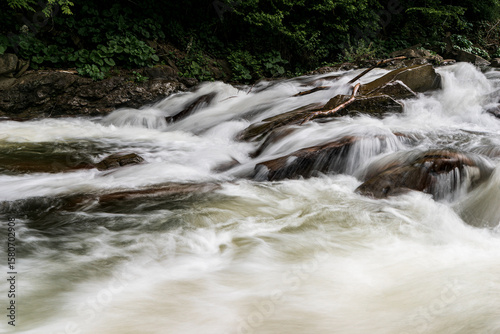 Wild river flowing through rocks in Bieszczady Mountains