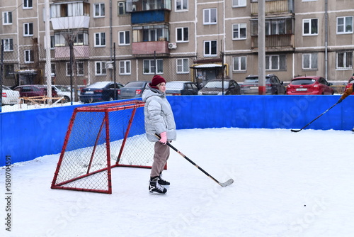 Photography People skate and play ice hockey in the yard