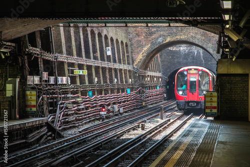 A London underground train approaching the platform of the tube station
