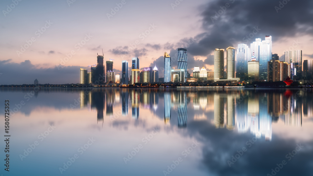 City skyline at dusk with reflections on the water City skyline at dusk with reflections on the water