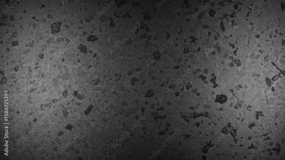 Textured dark gray background with irregular dark spots