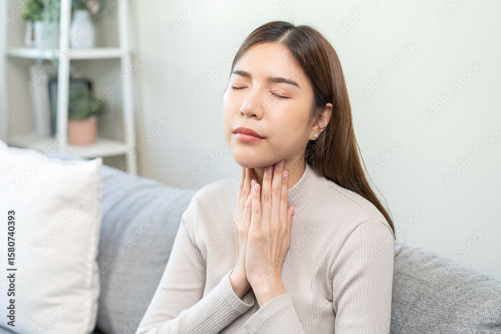 Sickness in inflaming asian young woman, girl use hand check self touch at sore throat, pain thyroid gland on neck or disease reflux, acid of suffer people at home. Medical and healthcare. Sickness in inflaming asian young woman, girl use hand check self touch at sore throat, pain thyroid gland on neck or disease reflux, acid of suffer people at home. Medical and healthcare.