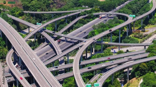 Aerial view of Chongqing Panlong Interchange showcasing busy traffic and intricate road networks during daylight