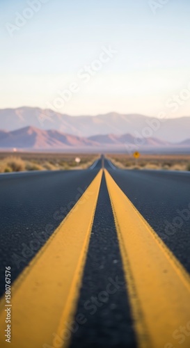 A long, straight road with yellow lines in the desert