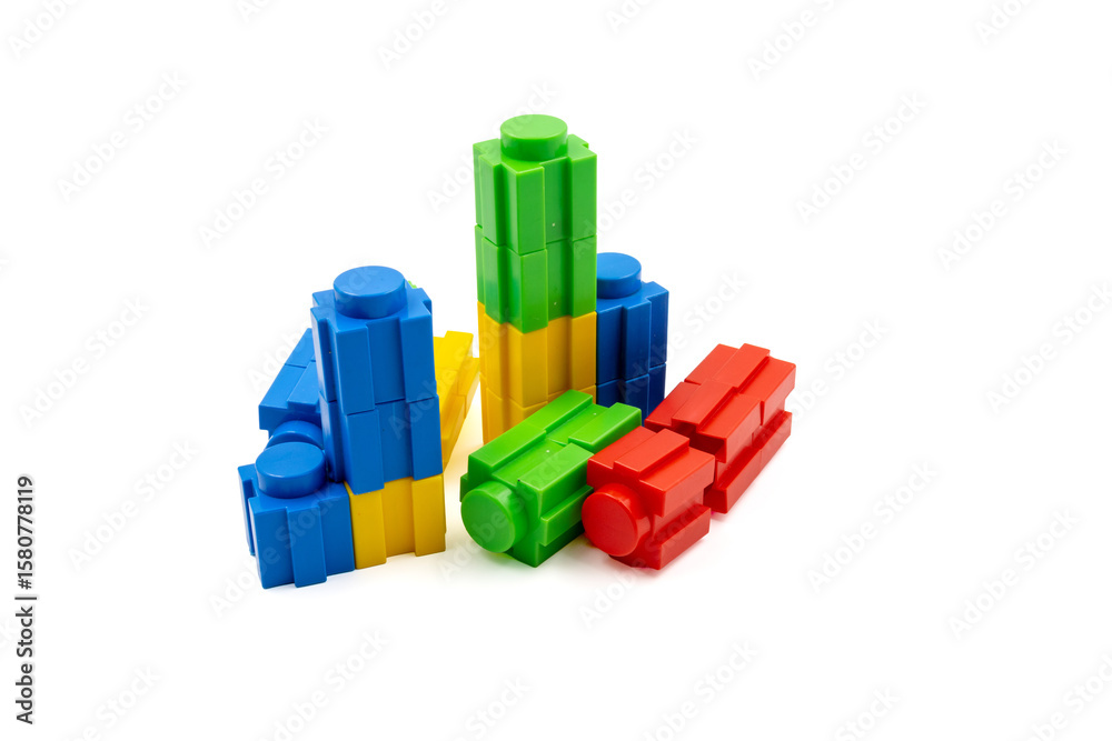 Obraz premium Colorful stacked plastic building blocks on white background
