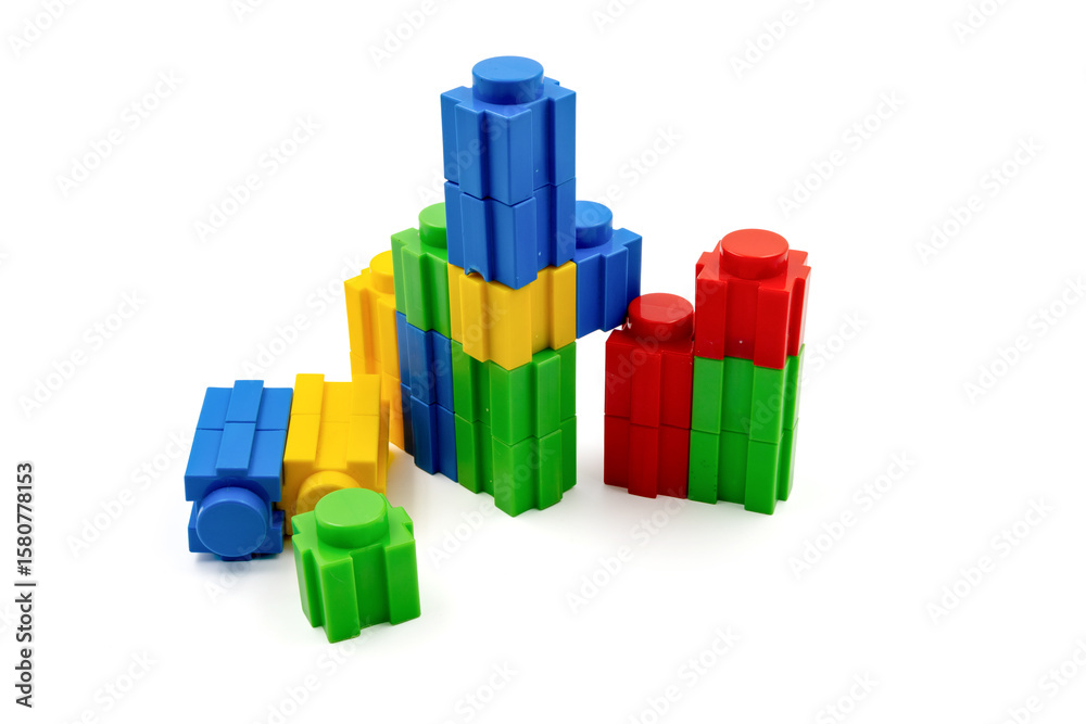 Fototapeta premium Colorful stacked plastic building blocks on white background