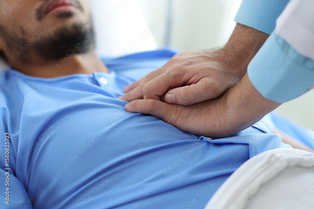 Obraz premium Doctor examining patient lying in hospital bed.