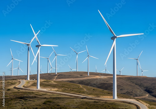 Wind turbines generate green electric power across a vast wind farm landscape under a blue sky, symbolizing renewable energy technology