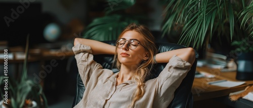 young lady project manager Take a time to procrastinate after completing a demanding task at work by relaxing in a comfortable chair, placing your hands behind your head
