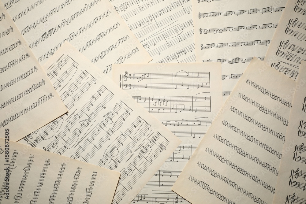 Fototapeta premium Sheets with musical notes as background, top view