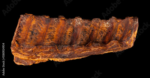 Smoked ribs isolated on black background.