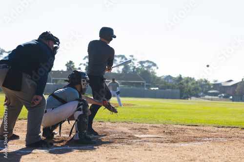 Diverse baseball players swinging bat and catching ball with glove and helmet at home plate