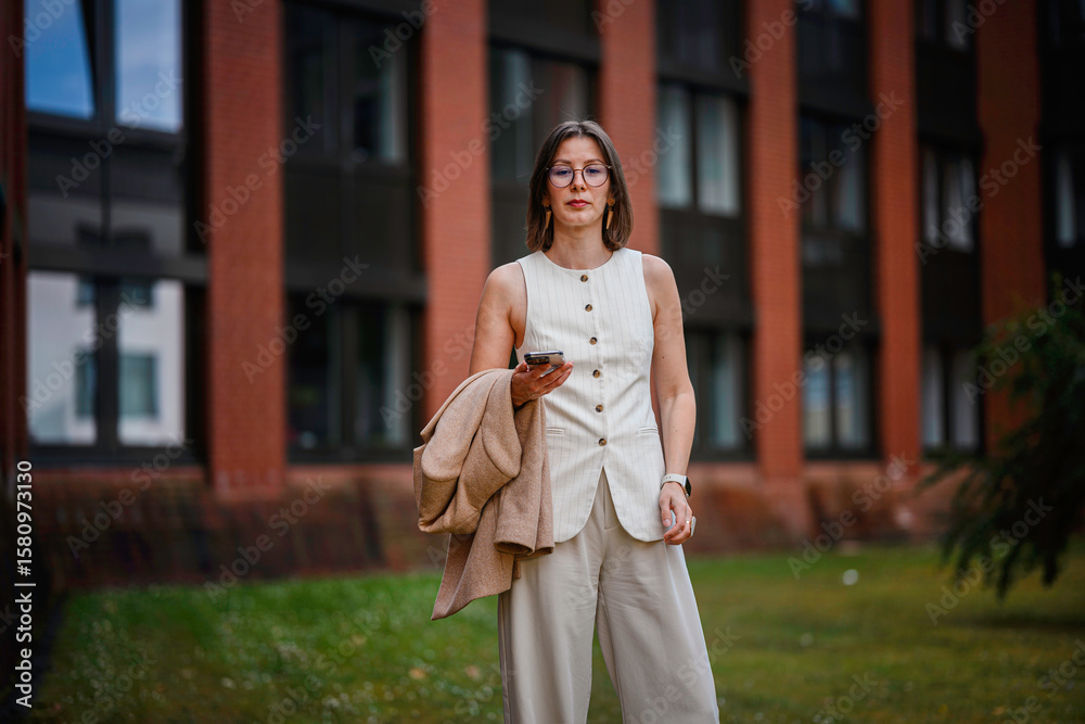 Fototapeta premium Confident Businesswoman Using Phone Outside Office
