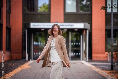 Joyful Woman Spinning Outside Jobcenter Building