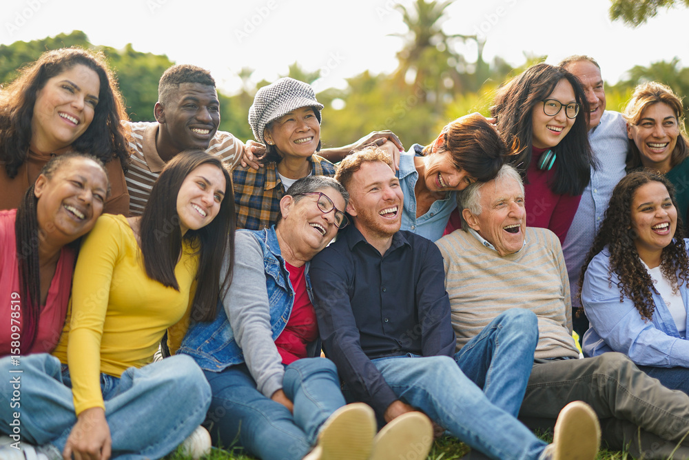 Obraz premium Crowd of happy multiracial people having fun together at city park - Multi generational friends, social gathering and community concept