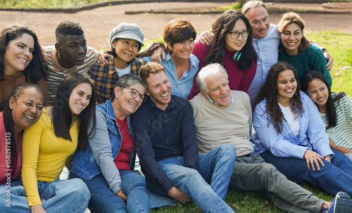 Crowd of multi generational people having fun together at city park - Social gathering, multiracial friends and community concept