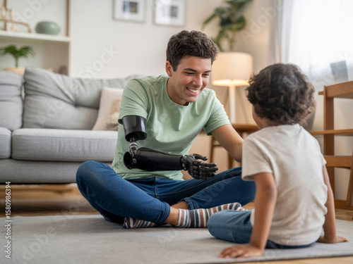 Young adult with prosthetic arm sitting on floor, smiling and engaging with small child in cozy living room setting, creating warm and joyful atmosphere