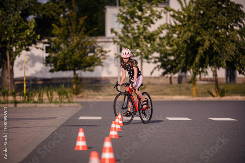 Girl Practicing Bike Skills on City Road with Cones