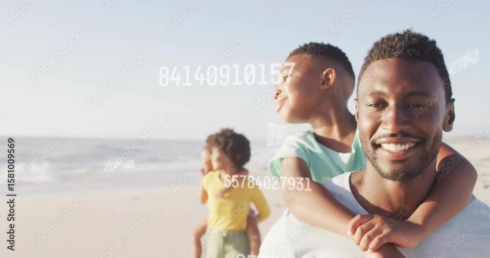 Father lifting son on shoulders and activating floating data overlay for technology demo