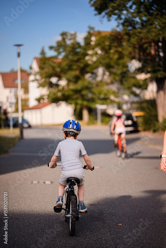 Wallpaper Mural Child Riding Bicycle on Quiet Neighborhood Street Torontodigital.ca