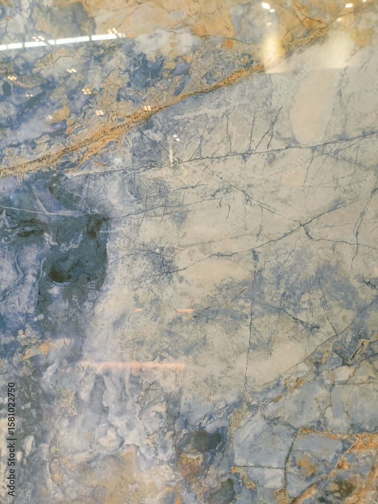 Fototapeta premium Blue stone texture with white and brown veins, resembling marble.