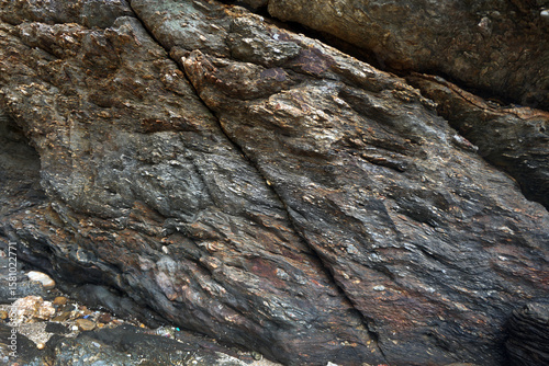 The surface of the gneiss cliffs of the mountains.  Texture and background of natural gneiss metamorphic rock.                               