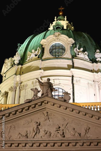 St. Charles's Church, baroque landmark in Vienna, Austria, illuminated at night.