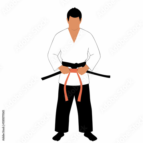 Male martial artist tying belt while standing in karate uniform  
