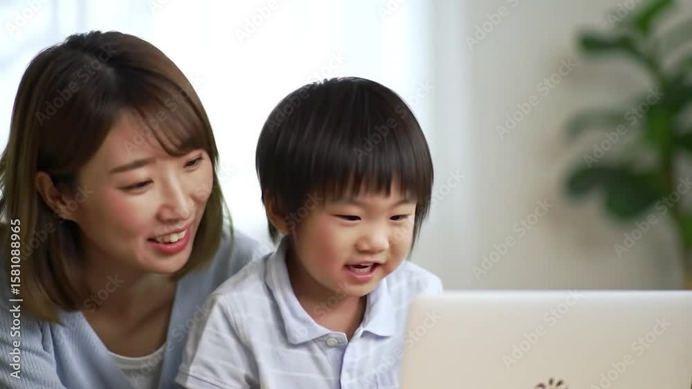 A woman and child using a laptop A woman and child using a laptop