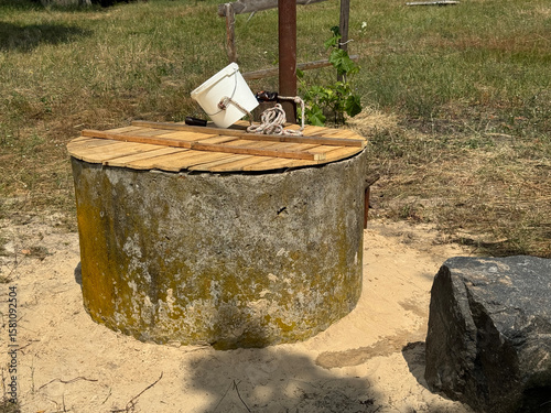 A mine well with concrete rings. Topped with white sand for protection and filtration.