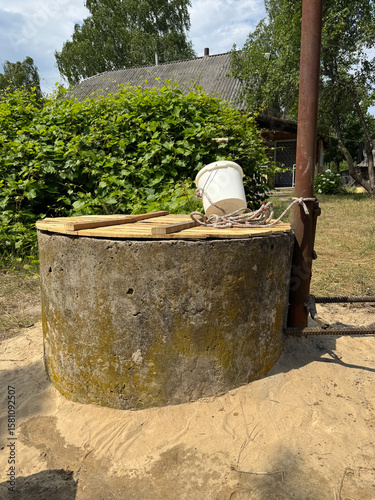 A mine well with concrete rings. Topped with white sand for protection and filtration.