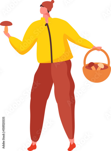 Young mushroomer walking through the woods in a yellow jacket and red trousers, holding a large freshly harvested mushroom in a wicker basket