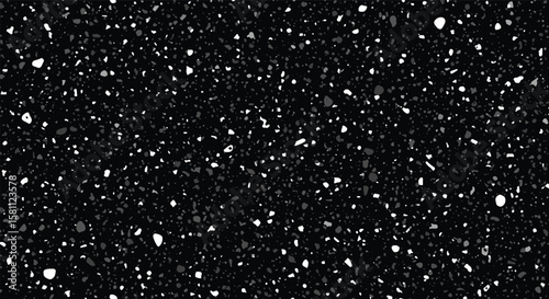 Abstract speckled dark background with many tiny white and gray dots scattered randomly