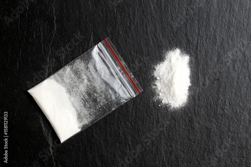 There is a bag of drugs on a black background.	