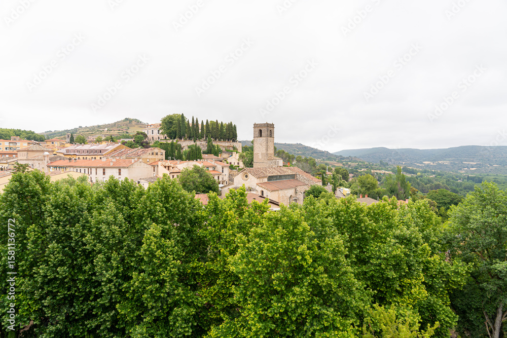Obraz premium Historic town of Brihuega in Guadalajara, Castilla-La Mancha with lush greenery and cloudy skies