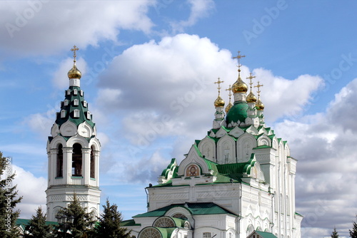 Temple with golden domes against the sky on a summer day.	
