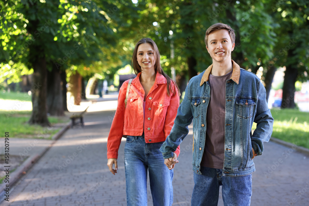 Obraz premium Lovely couple spending time together in park, space for text