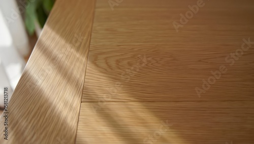 Wooden floor surface illuminated by sunlight through window blinds, highlighting texture, warm tones, and interior design simplicity in a modern room. Generative AI