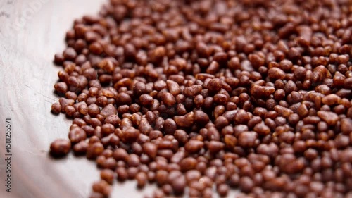 Coffee spice aromatic cocoa sprinkles in wooden bowl. Rotation