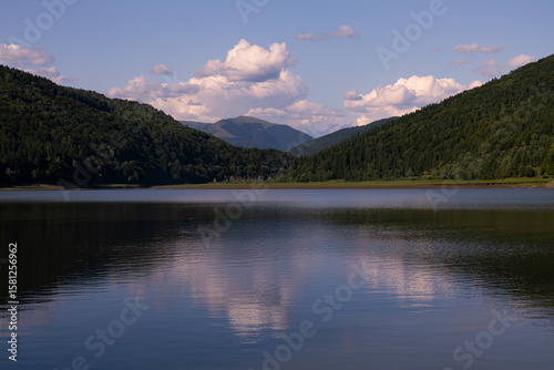 Sunset in the Mountains with Clouds and Reflection in the Lake Water