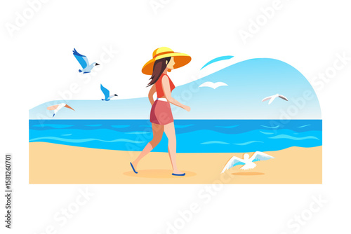 Woman in sun hat walks on beach with seagulls flying around