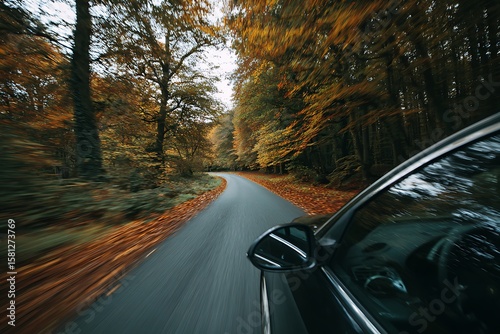 Wallpaper Mural A car drives down a winding road through a vibrant autumn forest, capturing the essence of a scenic road trip. Torontodigital.ca