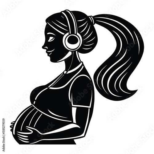 Pregnant woman listening to music with headphones and holding her belly